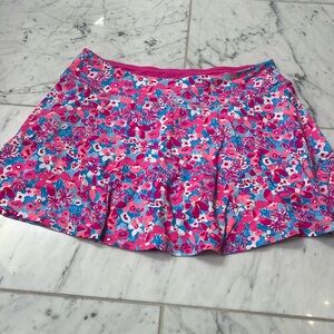 Lily Pulitzer pink and blue flowers squirt. Pink Bill and shorts underneath.